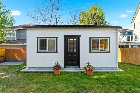 a front view of a house with a yard garage and outdoor seating