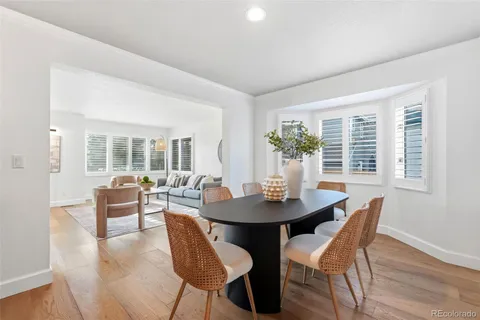 a dining room with furniture and wooden floor