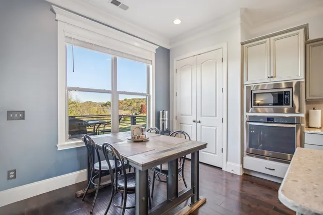 a room with furniture pool table and window
