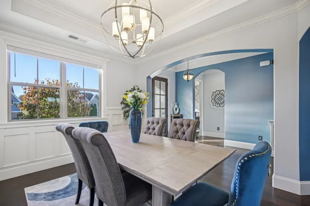 a bedroom with a large bed and a chandelier