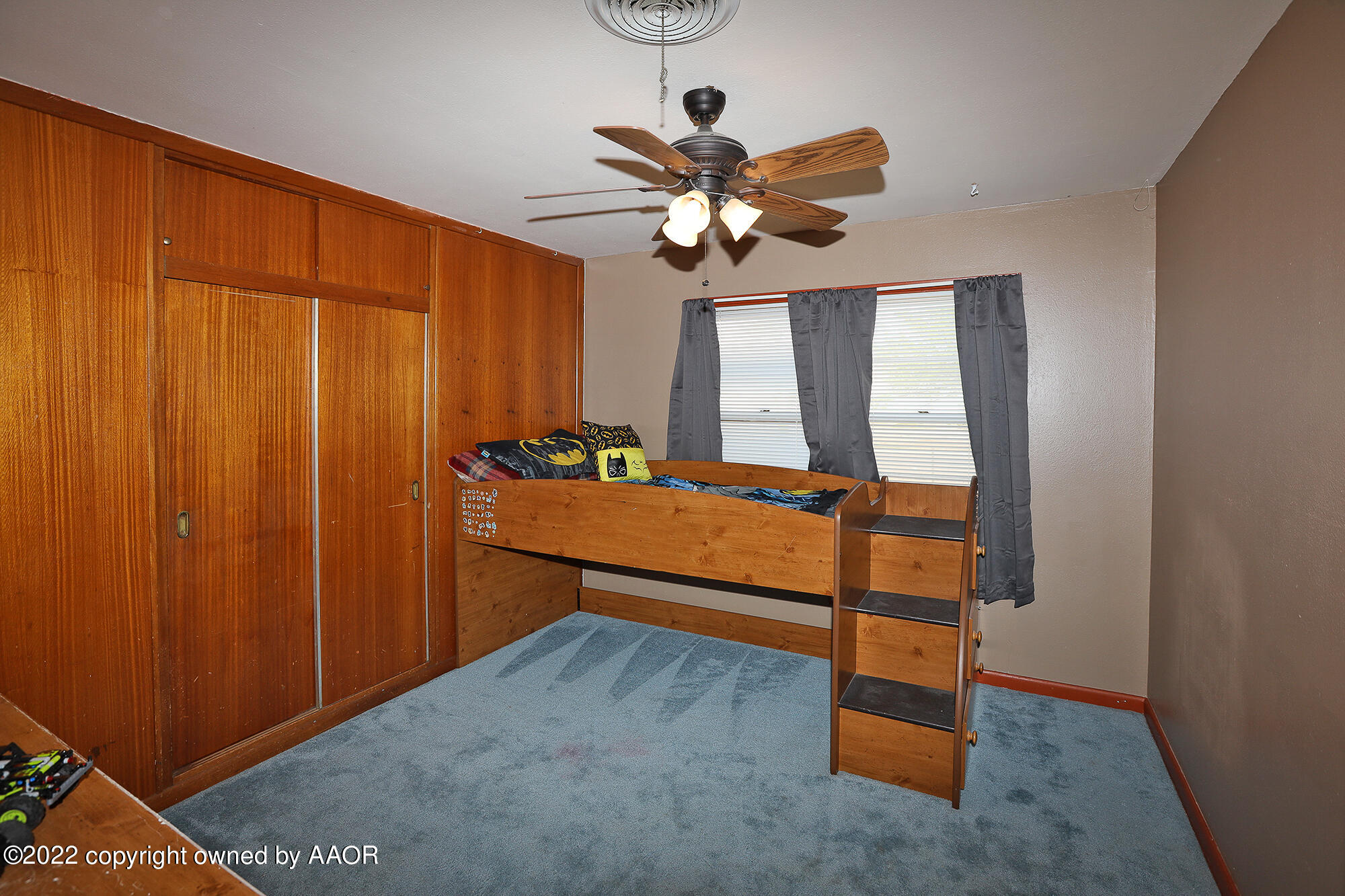 4318 South Hughes Street Amarillo, TX 79110 - Photo 11 of 25 a bedroom with a bed and a chandelier