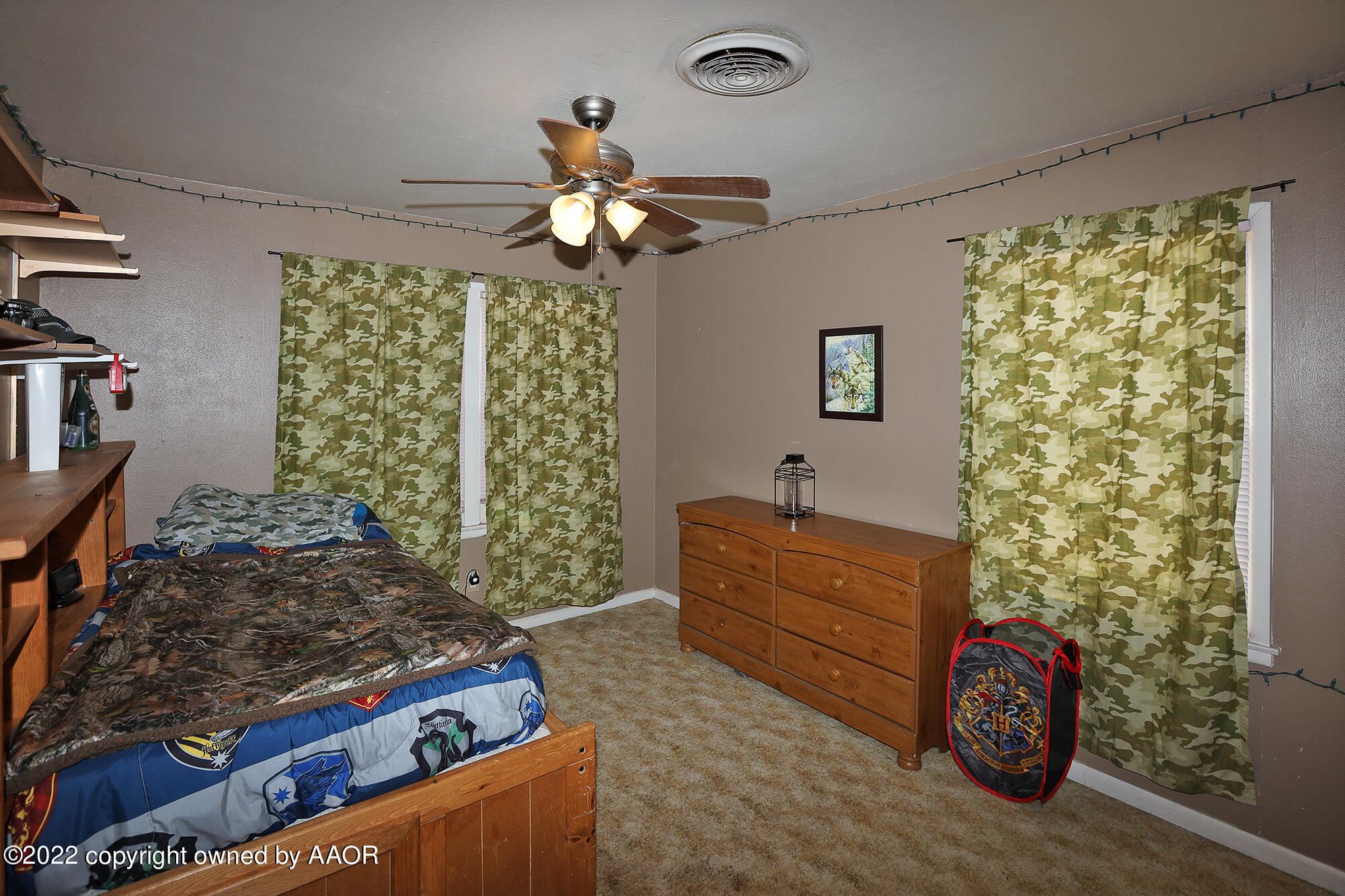 4318 South Hughes Street Amarillo, TX 79110 - Photo 14 of 25 a bedroom with a bed and a chandelier