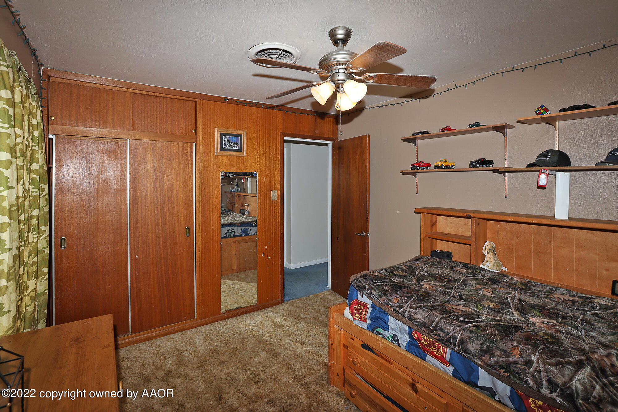 4318 South Hughes Street Amarillo, TX 79110 - Photo 15 of 25 a bedroom with a bed and a chandelier