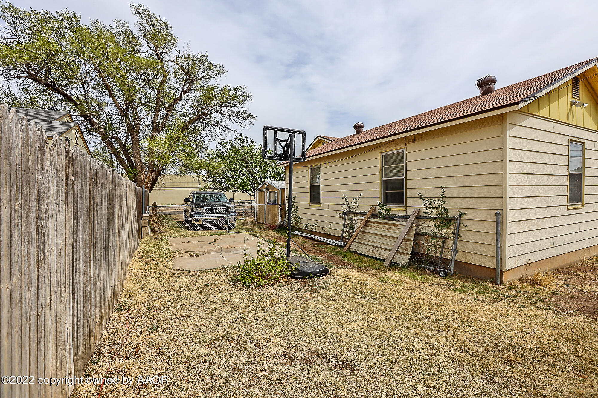 4318 South Hughes Street Amarillo, TX 79110 - Photo 21 of 25 a view of a backyard with a large tree