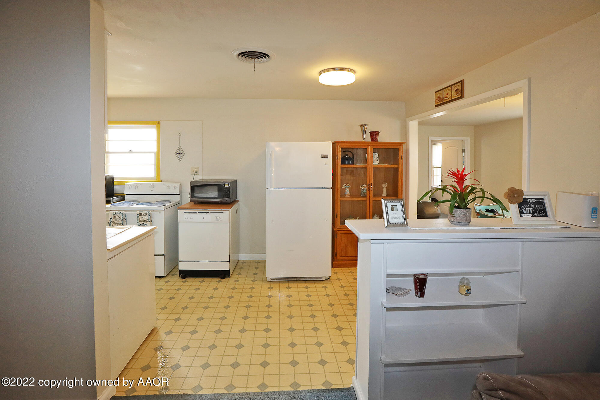 4318 South Hughes Street Amarillo, TX 79110 - Photo 6 of 25 a kitchen with a refrigerator sink and cabinets