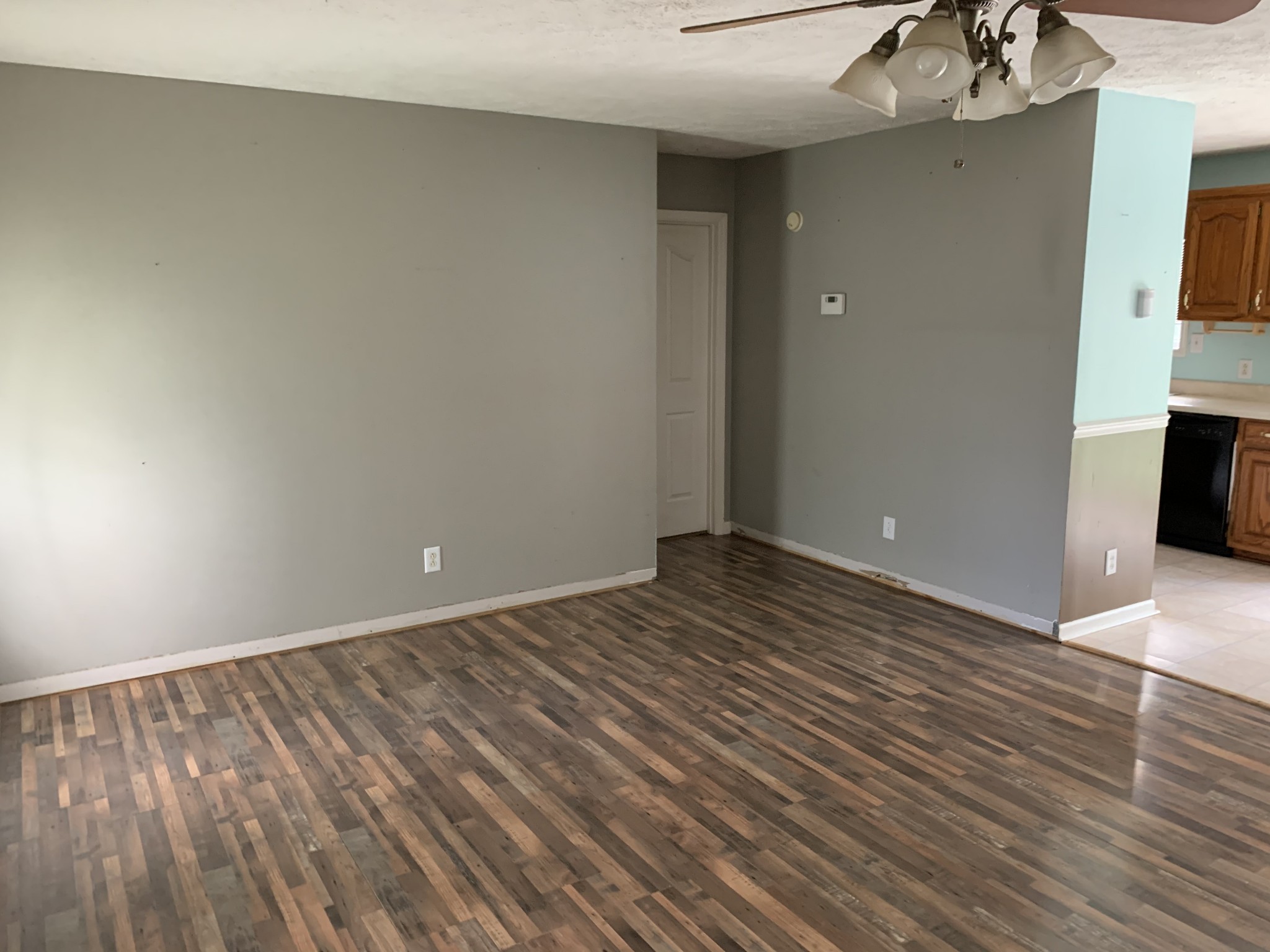 819 Hayes Road Lawrenceburg, TN 38464 - Photo 11 of 42 a view of an empty room with wooden floor and a kitchen