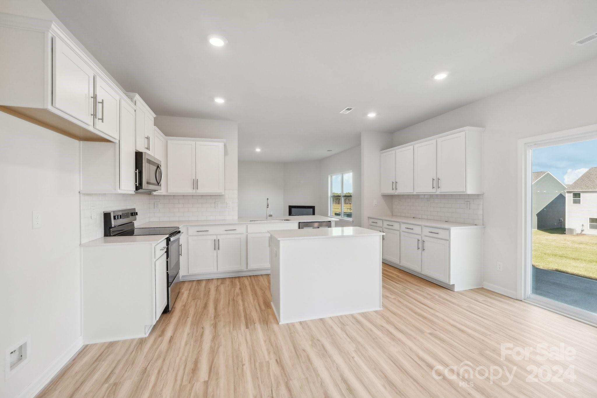 7914 Old Brk Road Sherrills Ford, NC 28673 - Photo 13 of 41 a kitchen with white cabinets appliances and wooden floor