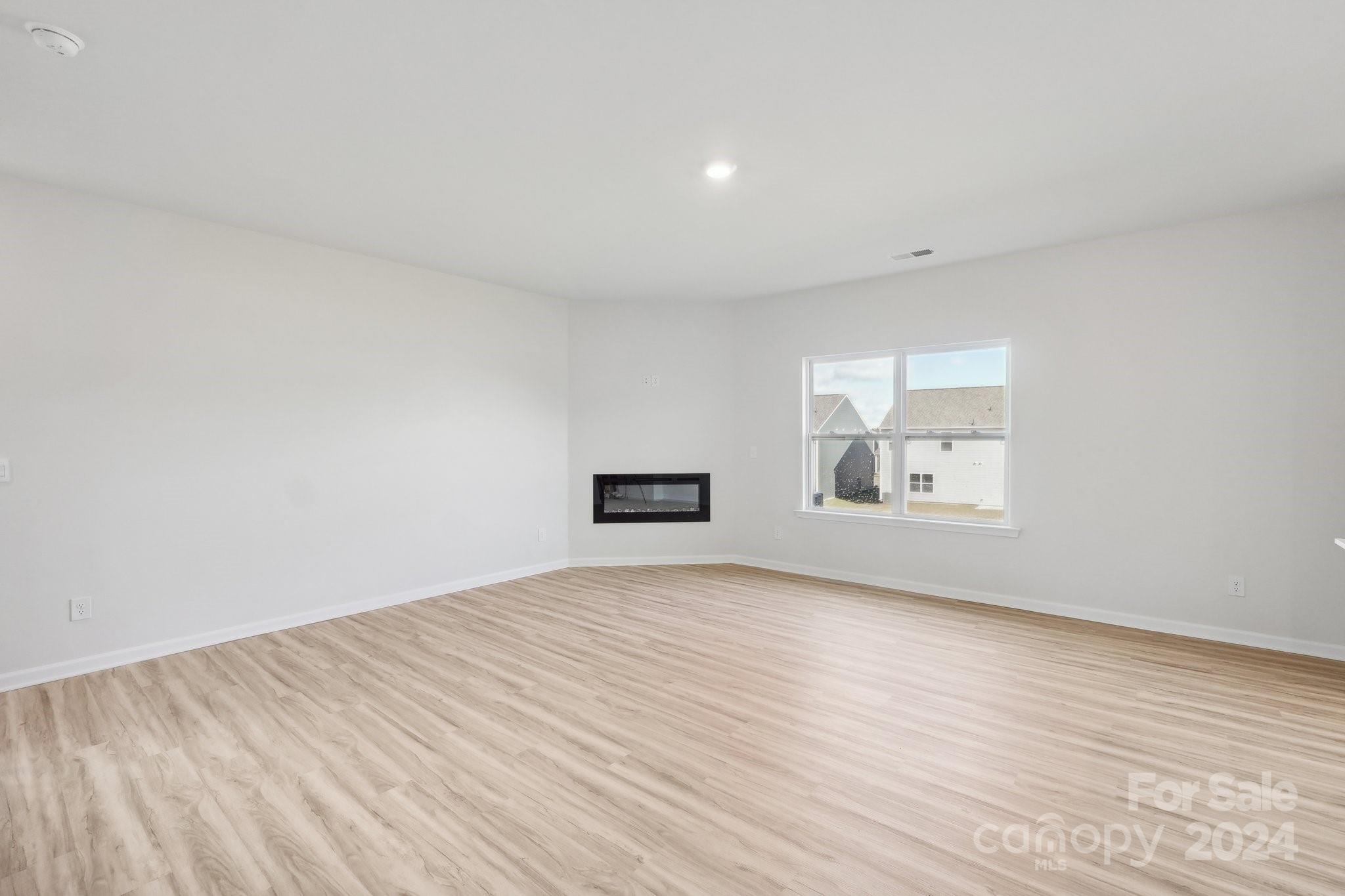 7914 Old Brk Road Sherrills Ford, NC 28673 - Photo 7 of 41 a view of an empty room with wooden floor and a window