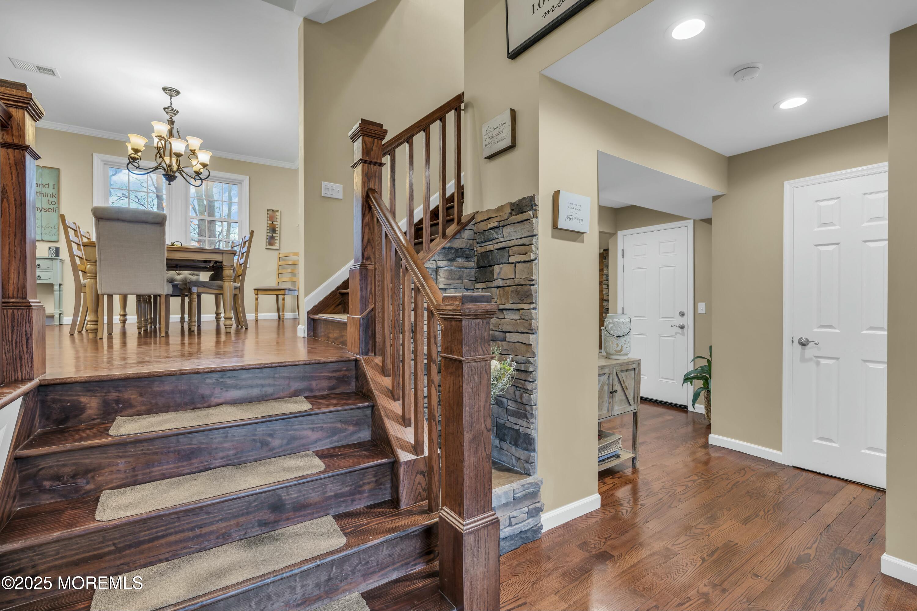 16 Glenarden Drive Howell, NJ 07731 - Photo 14 of 63 a view of a hallway with wooden floor and staircase