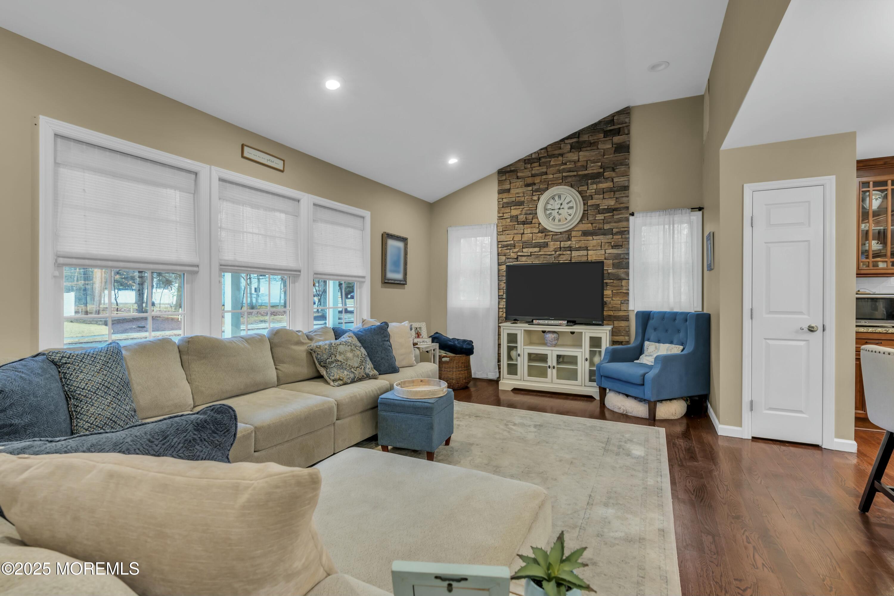 16 Glenarden Drive Howell, NJ 07731 - Photo 20 of 63 a living room with furniture fireplace and a flat screen tv