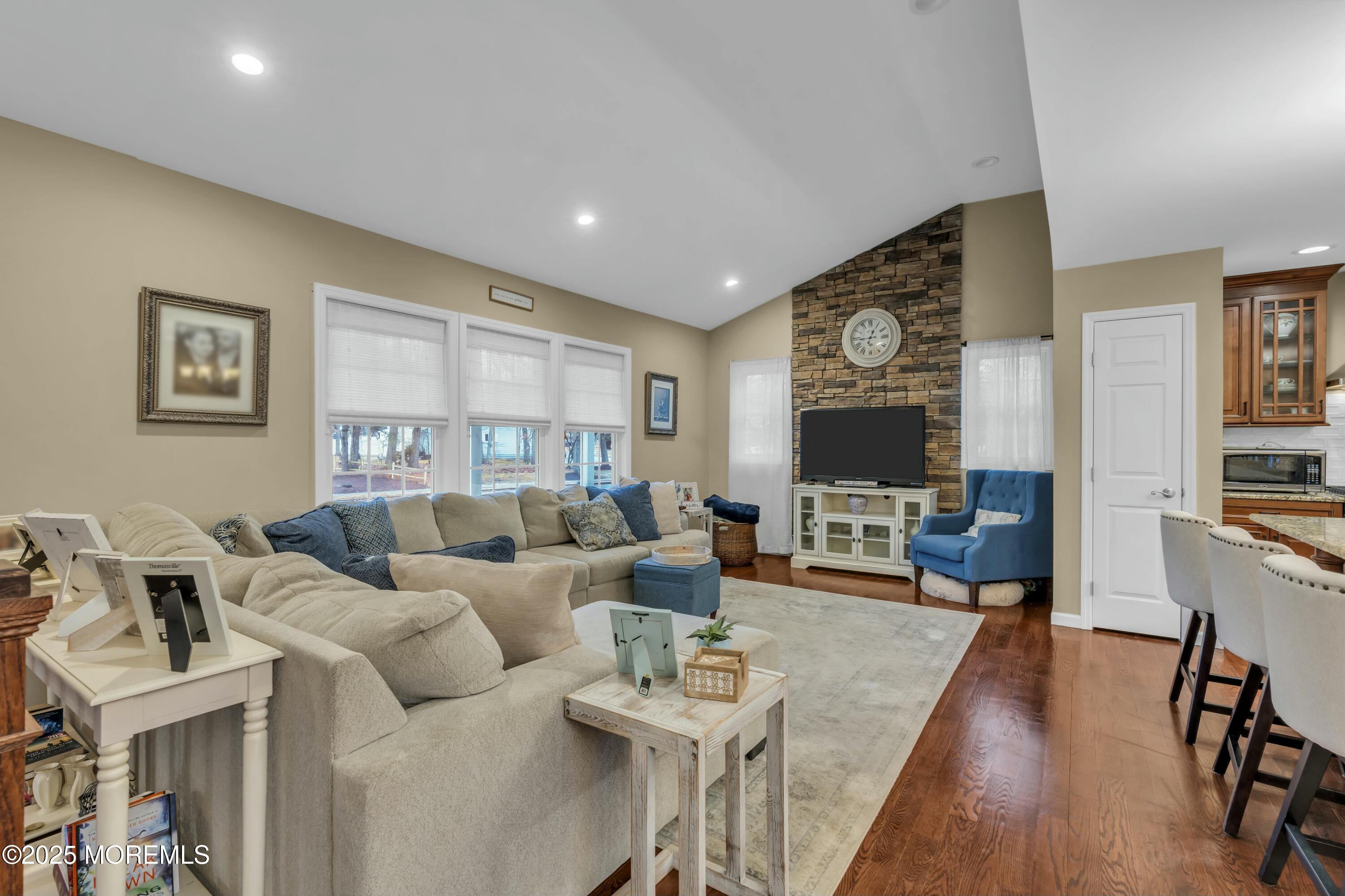16 Glenarden Drive Howell, NJ 07731 - Photo 21 of 63 a living room with furniture flat screen tv and a fireplace