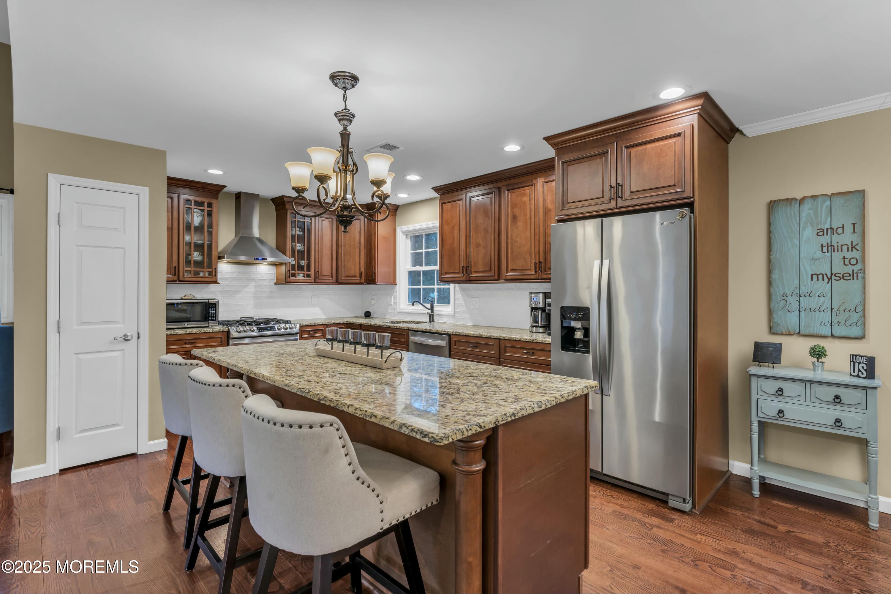 16 Glenarden Drive Howell, NJ 07731 - Photo 30 of 63 a kitchen with stainless steel appliances granite countertop a kitchen island a stove a refrigerator a sink and a refrigerator