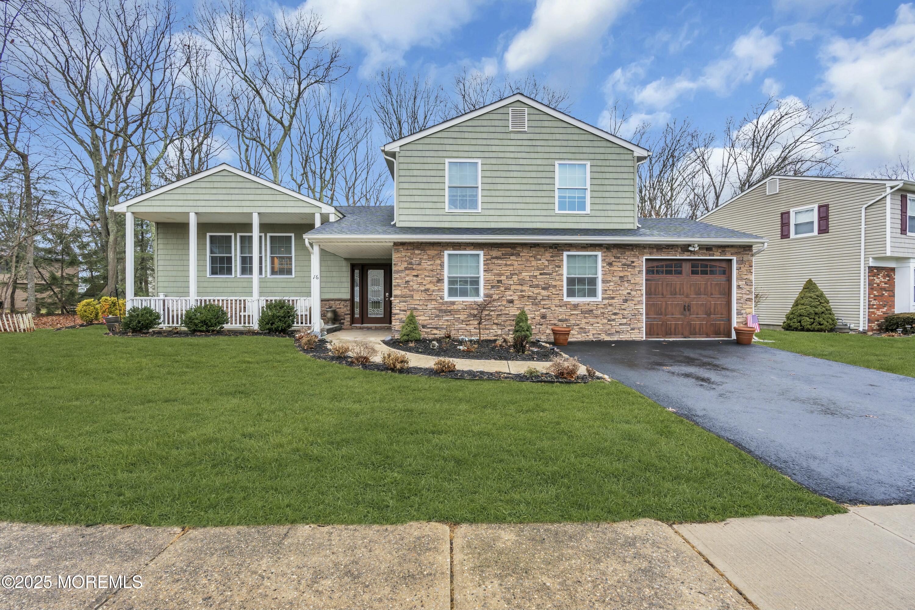 16 Glenarden Drive Howell, NJ 07731 - Photo 3 of 63 a front view of a house with a garden