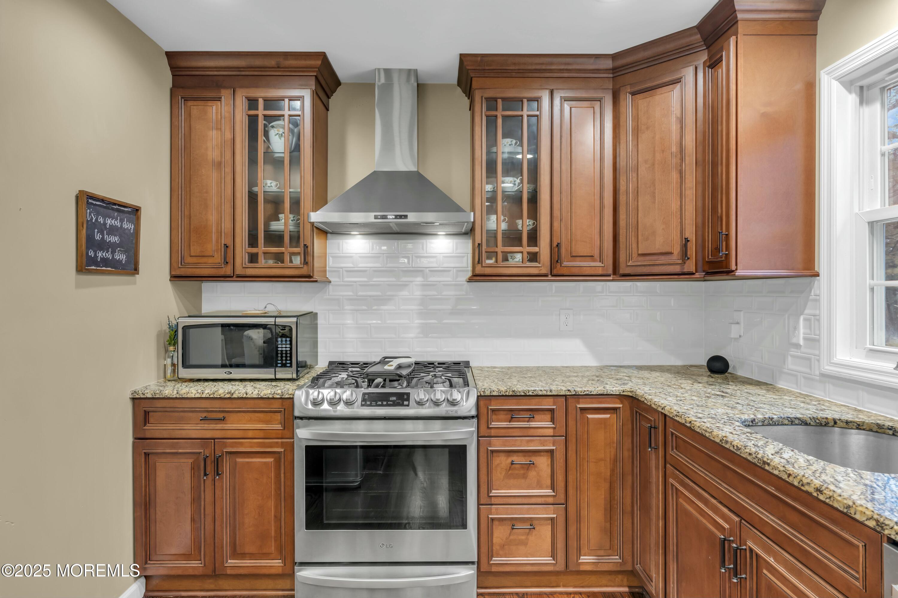 16 Glenarden Drive Howell, NJ 07731 - Photo 31 of 63 a kitchen with stainless steel appliances granite countertop a stove and a microwave