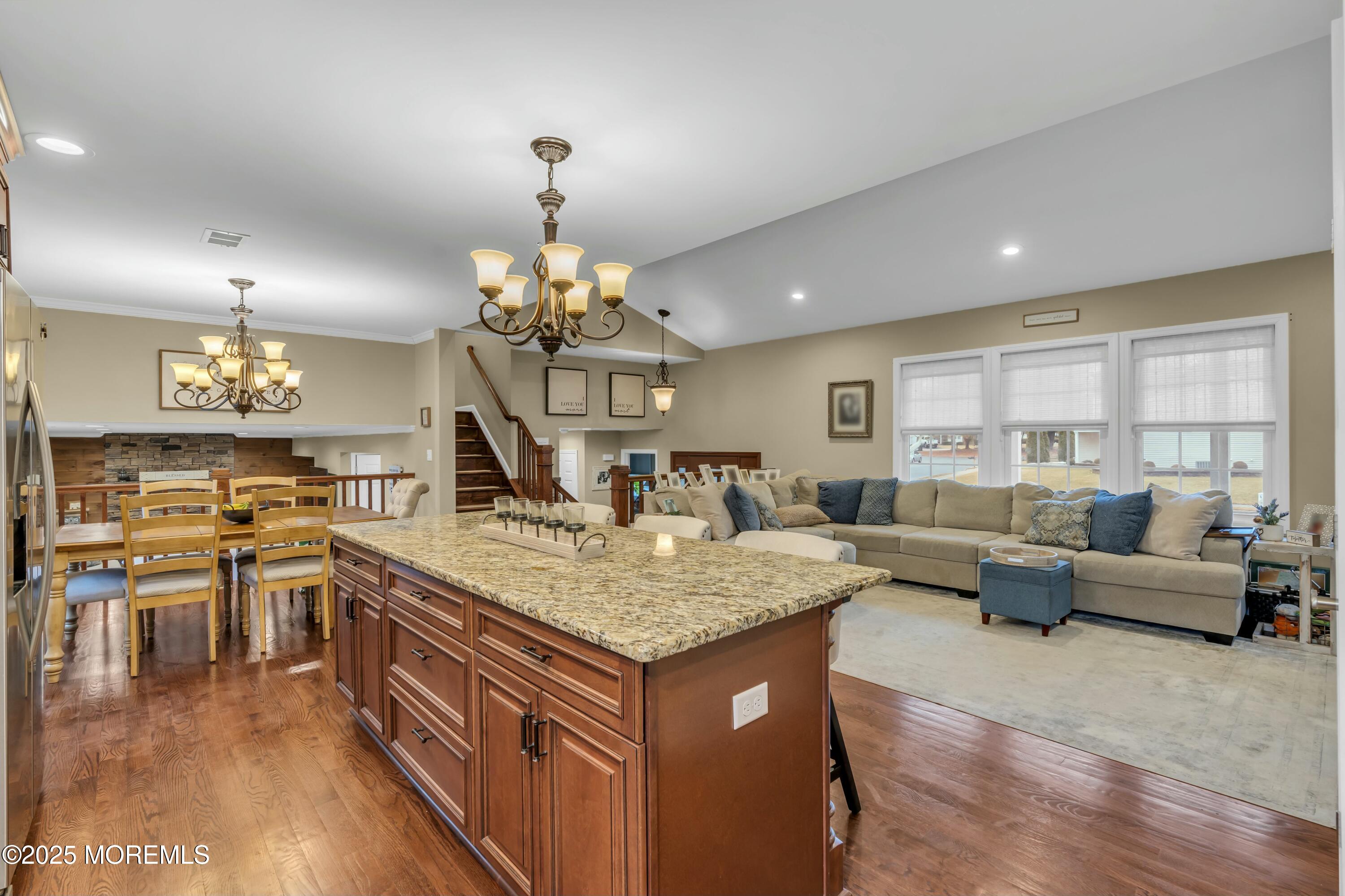16 Glenarden Drive Howell, NJ 07731 - Photo 33 of 63 a view of living room kitchen island dining table and wooden floor
