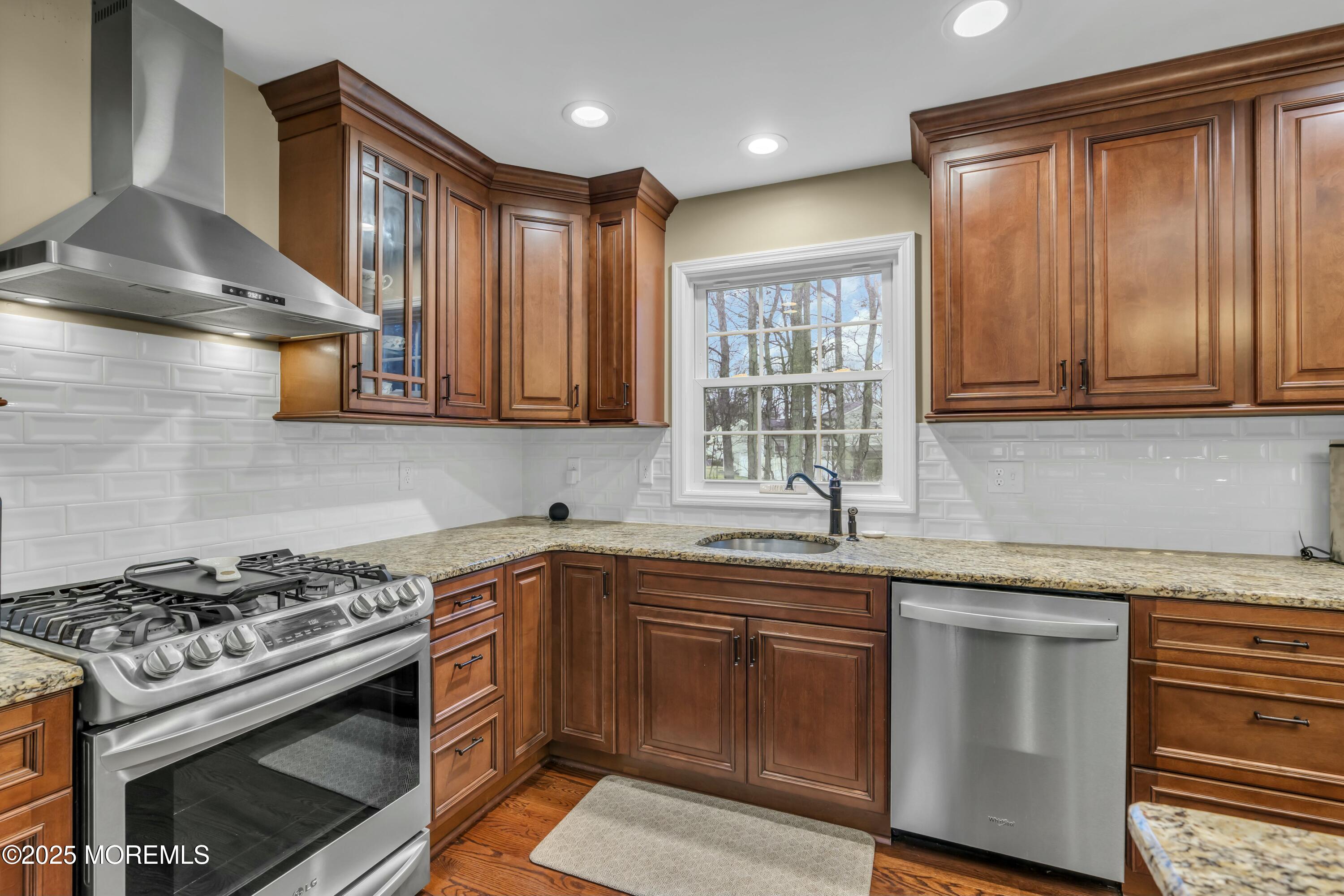 16 Glenarden Drive Howell, NJ 07731 - Photo 34 of 63 a kitchen with stainless steel appliances a stove a sink cabinet and a microwave