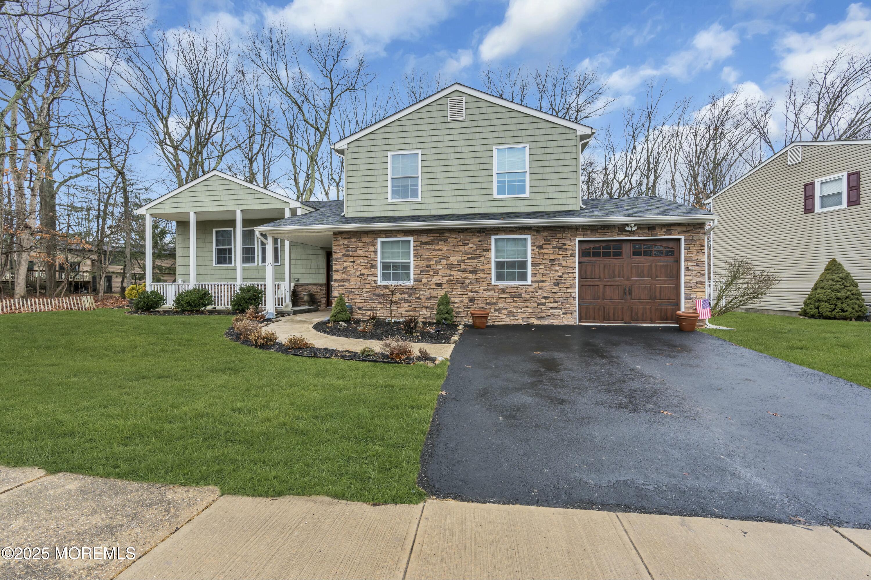 16 Glenarden Drive Howell, NJ 07731 - Photo 5 of 63 a front view of a house with a garden