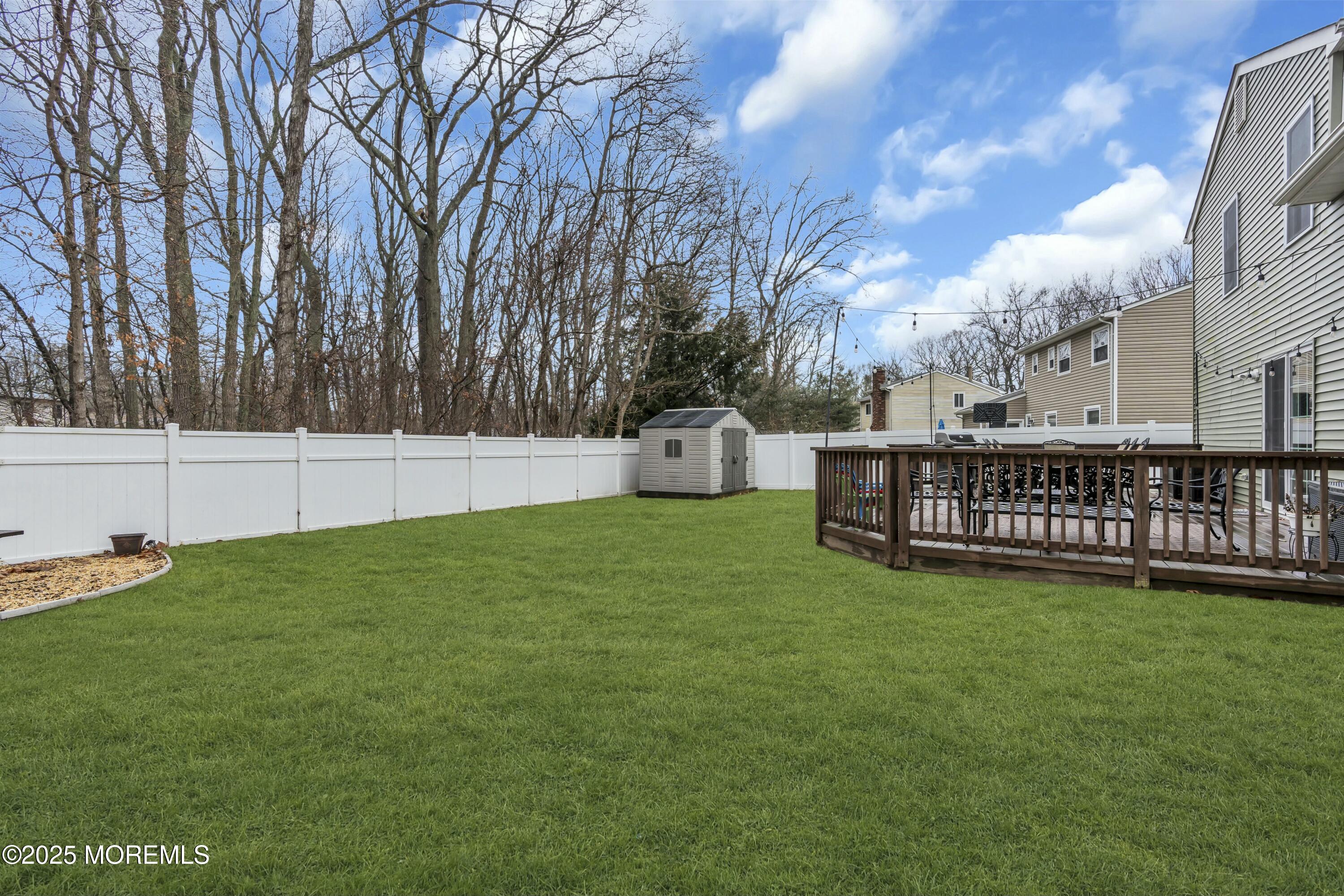 16 Glenarden Drive Howell, NJ 07731 - Photo 53 of 63 a view of a yard with large trees and wooden fence