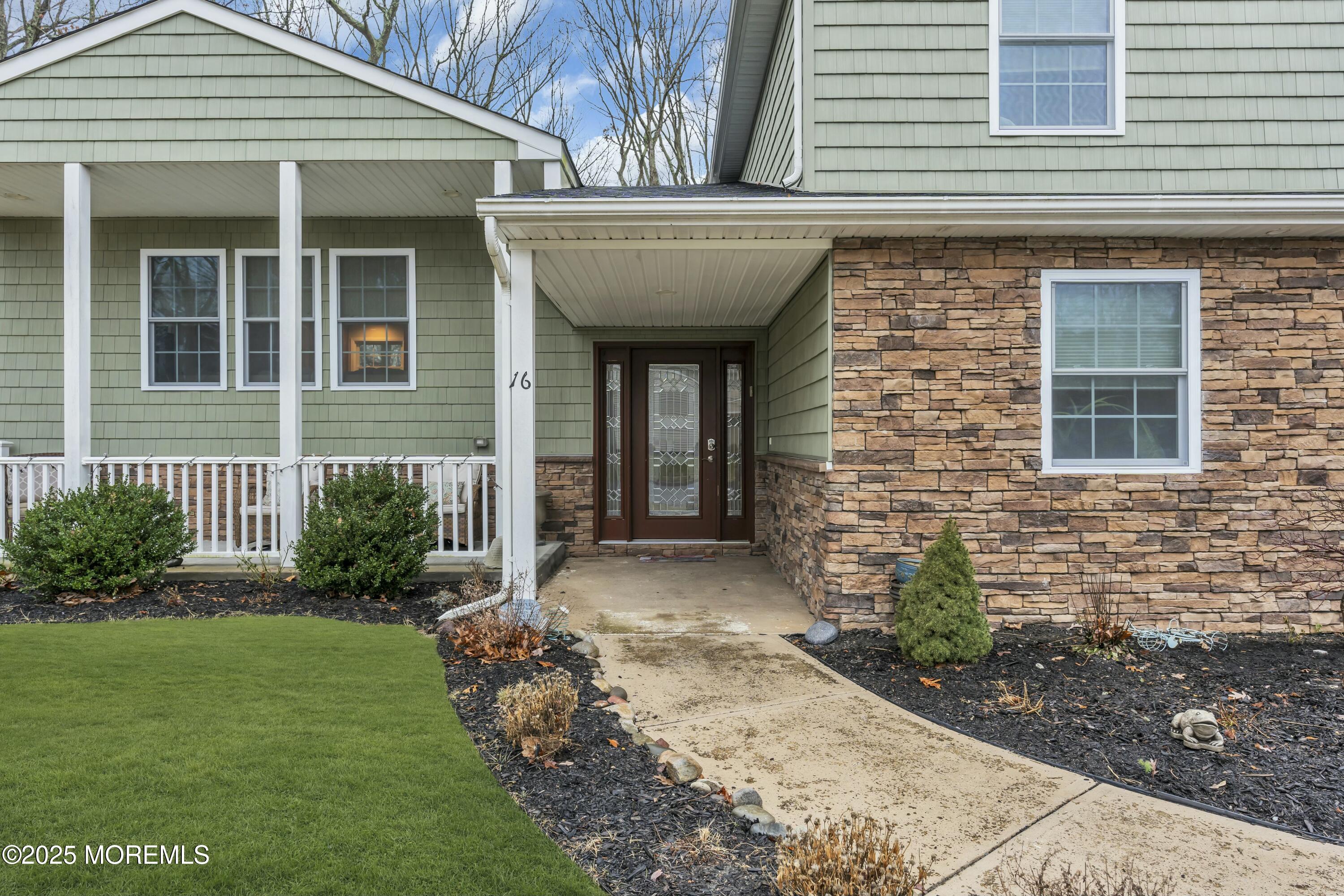 16 Glenarden Drive Howell, NJ 07731 - Photo 7 of 63 a view of a house with brick walls and a yard with plants