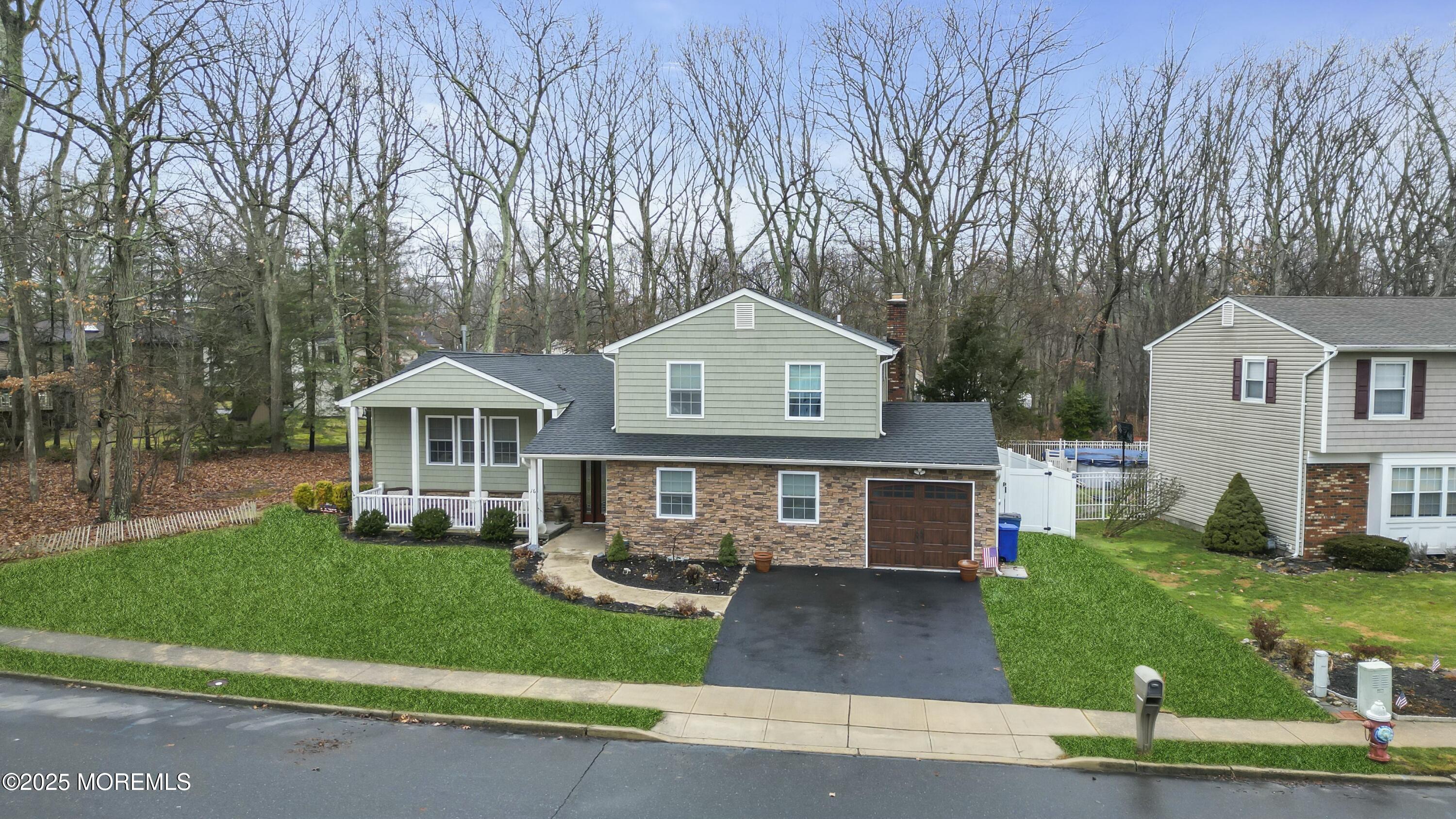 16 Glenarden Drive Howell, NJ 07731 - Photo 8 of 63 a front view of a house with a yard and garage