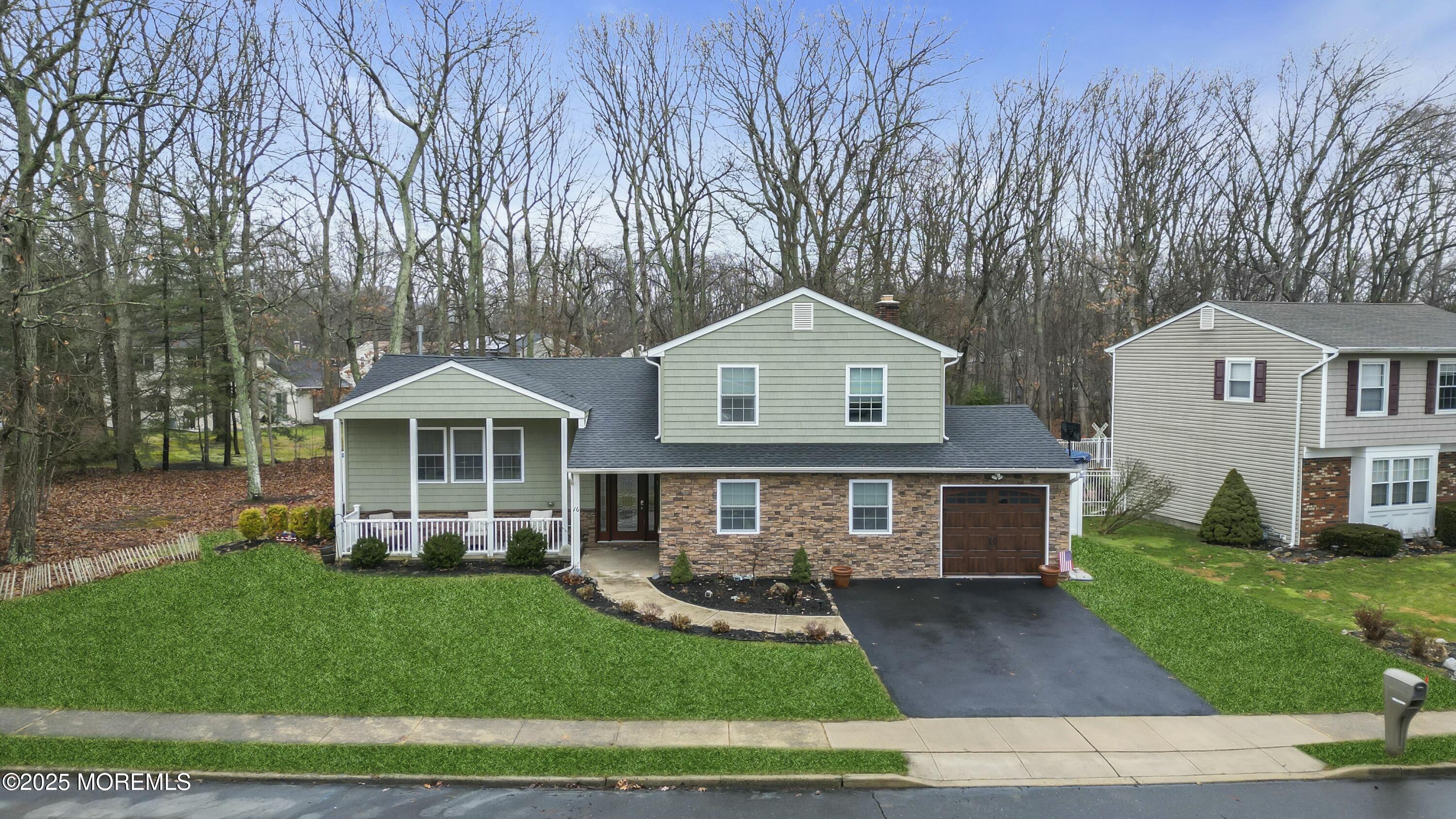 16 Glenarden Drive Howell, NJ 07731 - Photo 9 of 63 a front view of a house with a yard