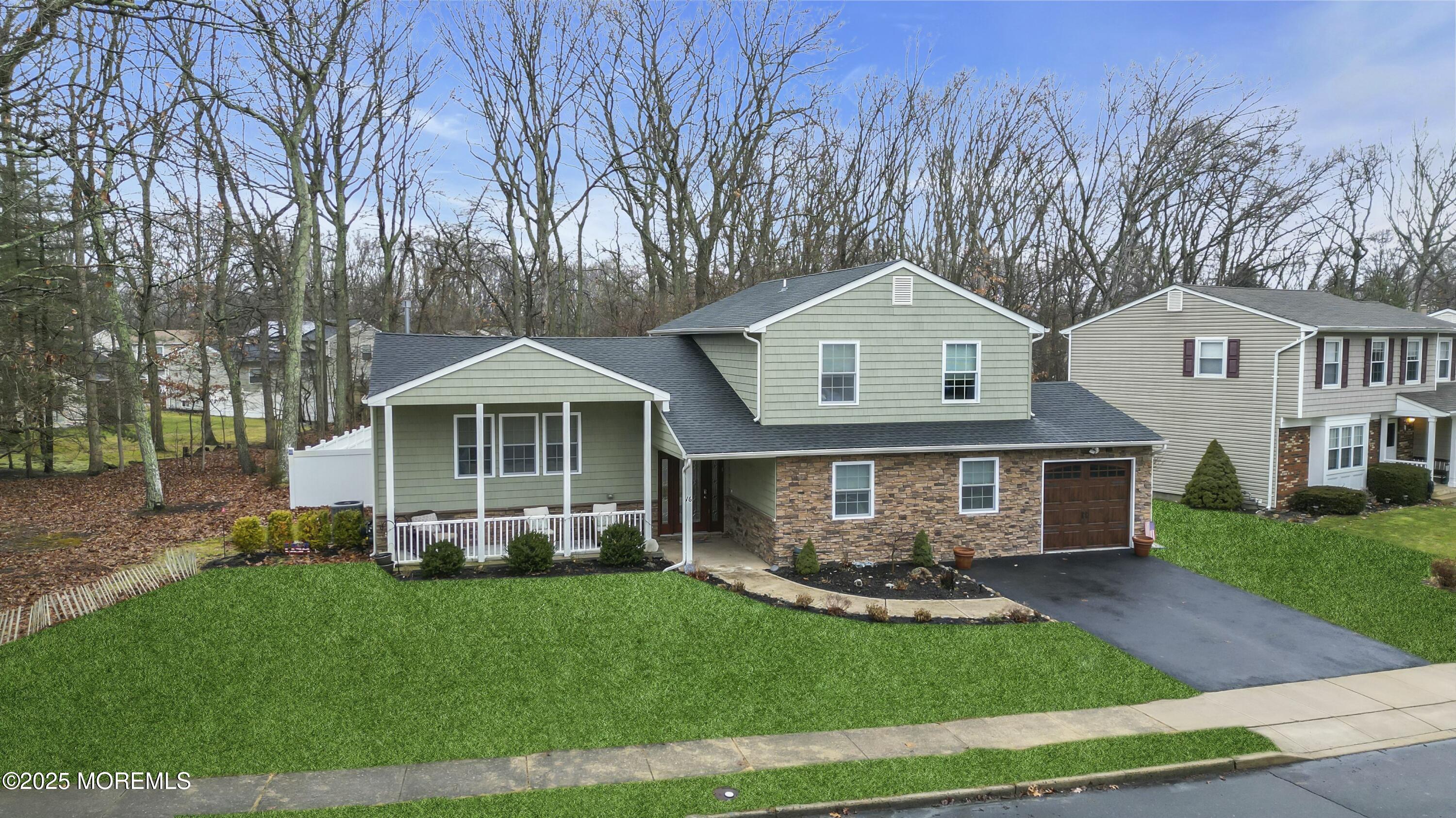 16 Glenarden Drive Howell, NJ 07731 - Photo 10 of 63 a front view of a house with a yard