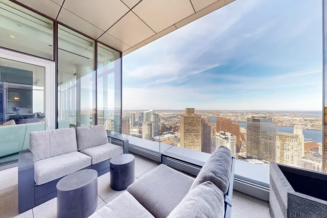 a living room with furniture and a floor to ceiling window