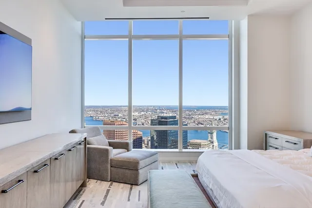 a large bedroom with a large bed and a table