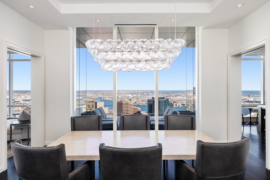 1 Franklin Street, Unit PH4B Boston, MA 02110 - Photo 2 of 14 a view of a dining room with furniture and chandelier