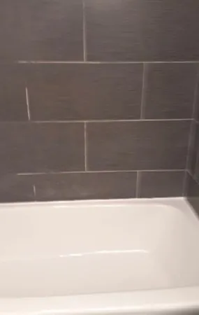 a black and white photo of a bathtub