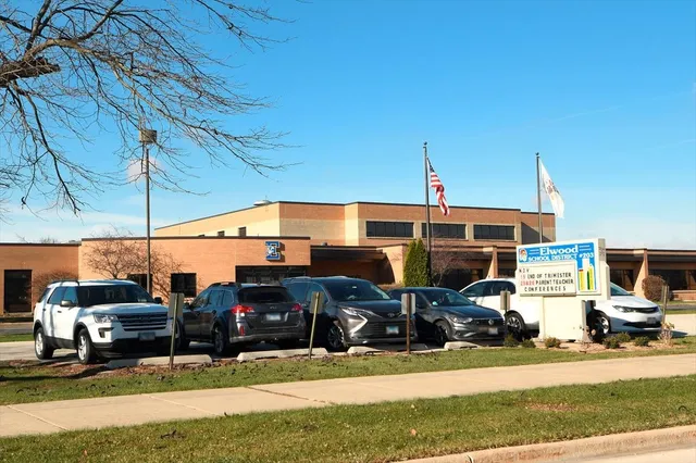 a sign board with yard in the back