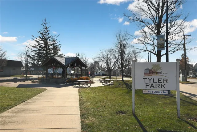 a view of a park with iron fence