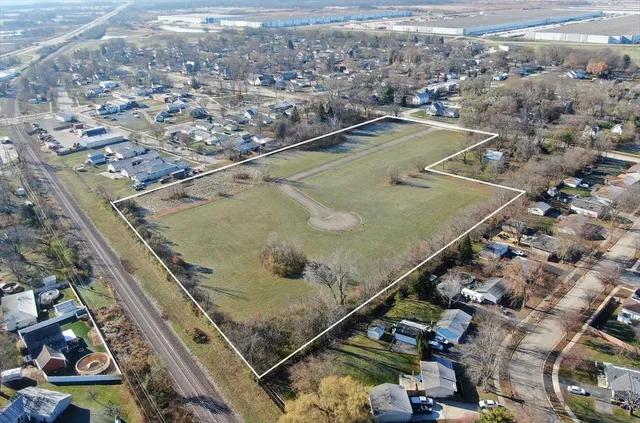 an aerial view of residential houses with outdoor space