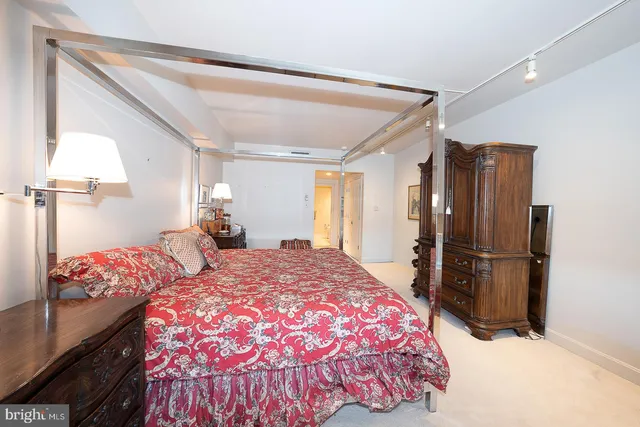 a bedroom with a bed dresser and a window