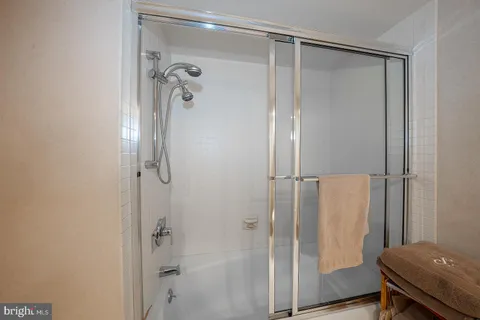 a bathroom with a shower and a glass door