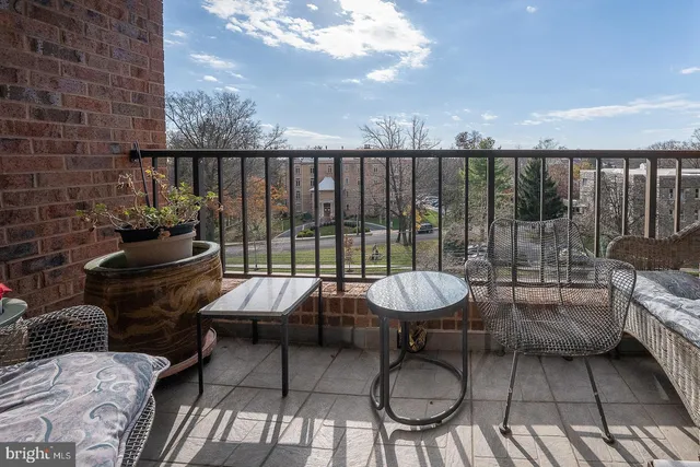 a balcony with seating area and outdoor seating
