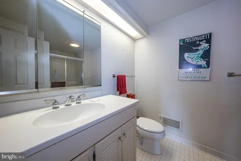 a bathroom with a sink mirror vanity and toilet