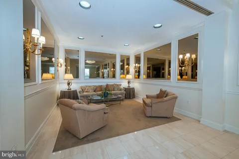 a living room with furniture and large windows