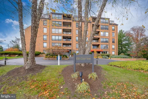 a view of a building with garden and sitting area