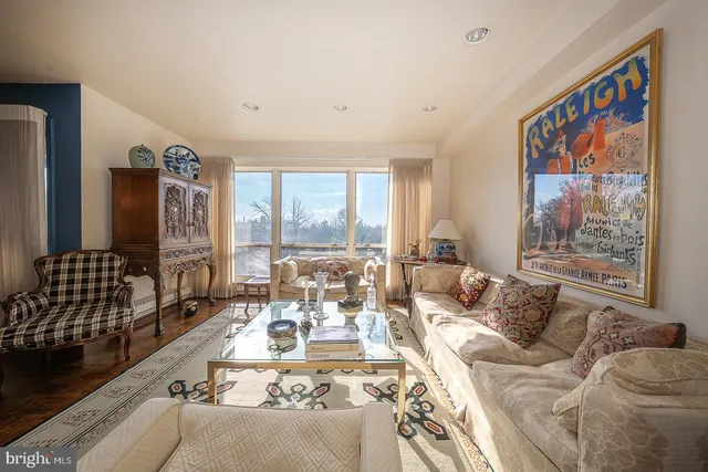a living room with furniture large window and a table
