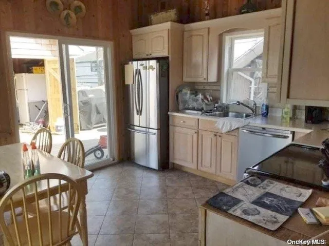 a kitchen with stainless steel appliances granite countertop a refrigerator and a stove
