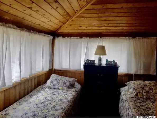 a bed sitting in a bedroom next to a window