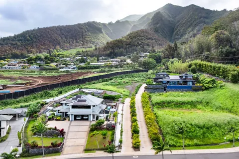 an aerial view of a house with garden space lake view and mountain view