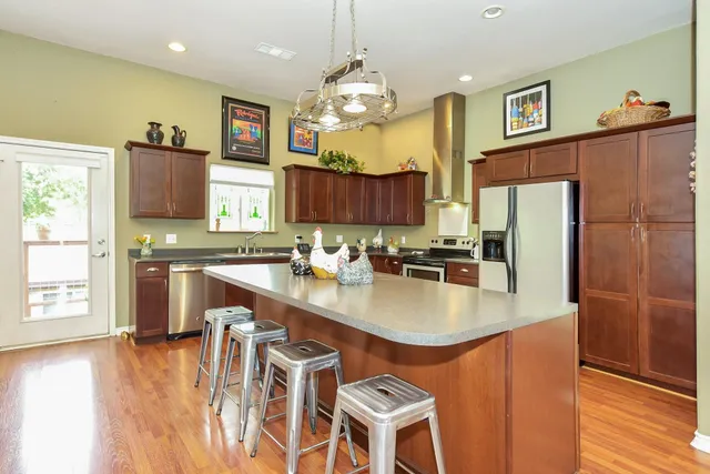 a spacious bedroom with a bed and a flat screen tv