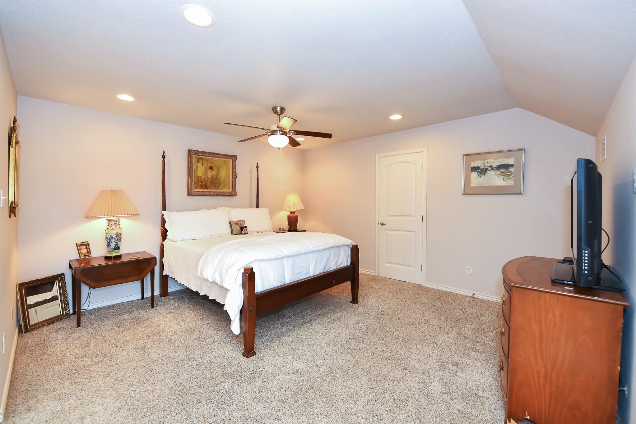 226 Valmar Kemah, TX 77565 - Photo 13 of 29 a spacious bedroom with a bed and a flat screen tv