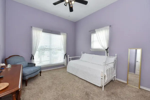 a bedroom with a bed and a painting on the wall