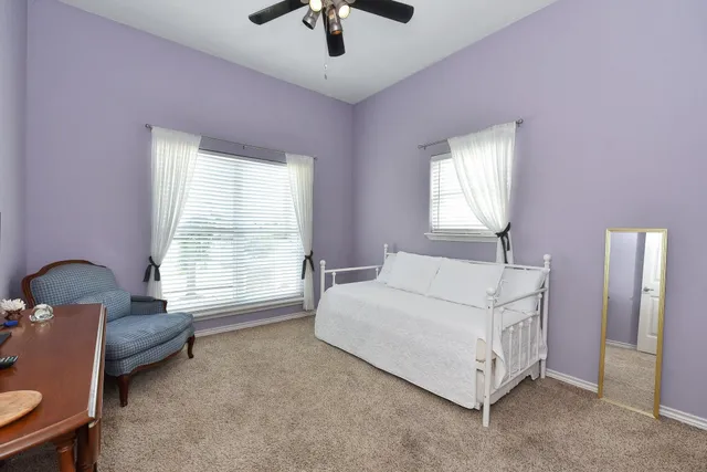 a bedroom with a bed and a painting on the wall