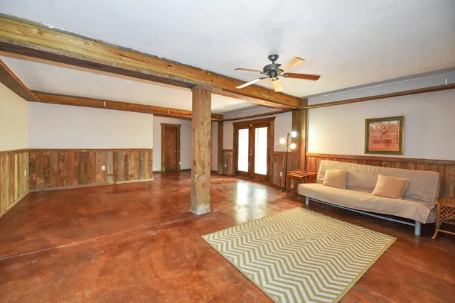 a view of a livingroom with furniture and staircase