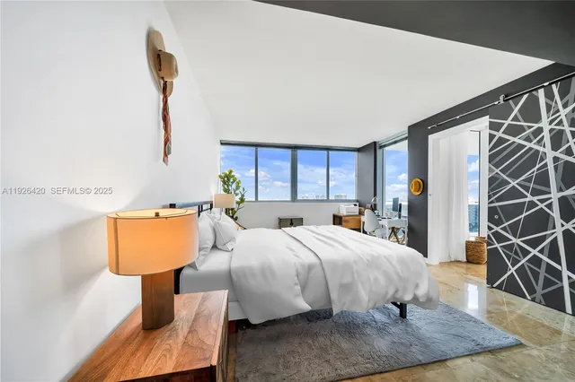 a bedroom with a bed a couch and dresser