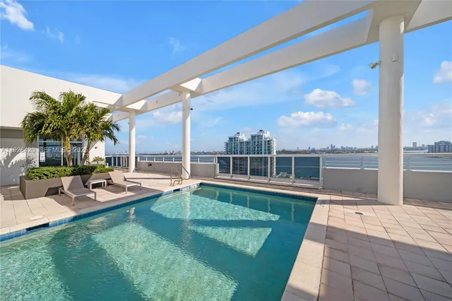 a view of a swimming pool with chairs in patio